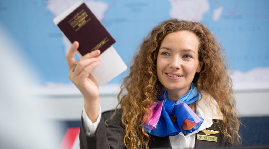 woman-officer-giving-passport-and-boarding-pass-to-2025-03-08-16-46-45-utc